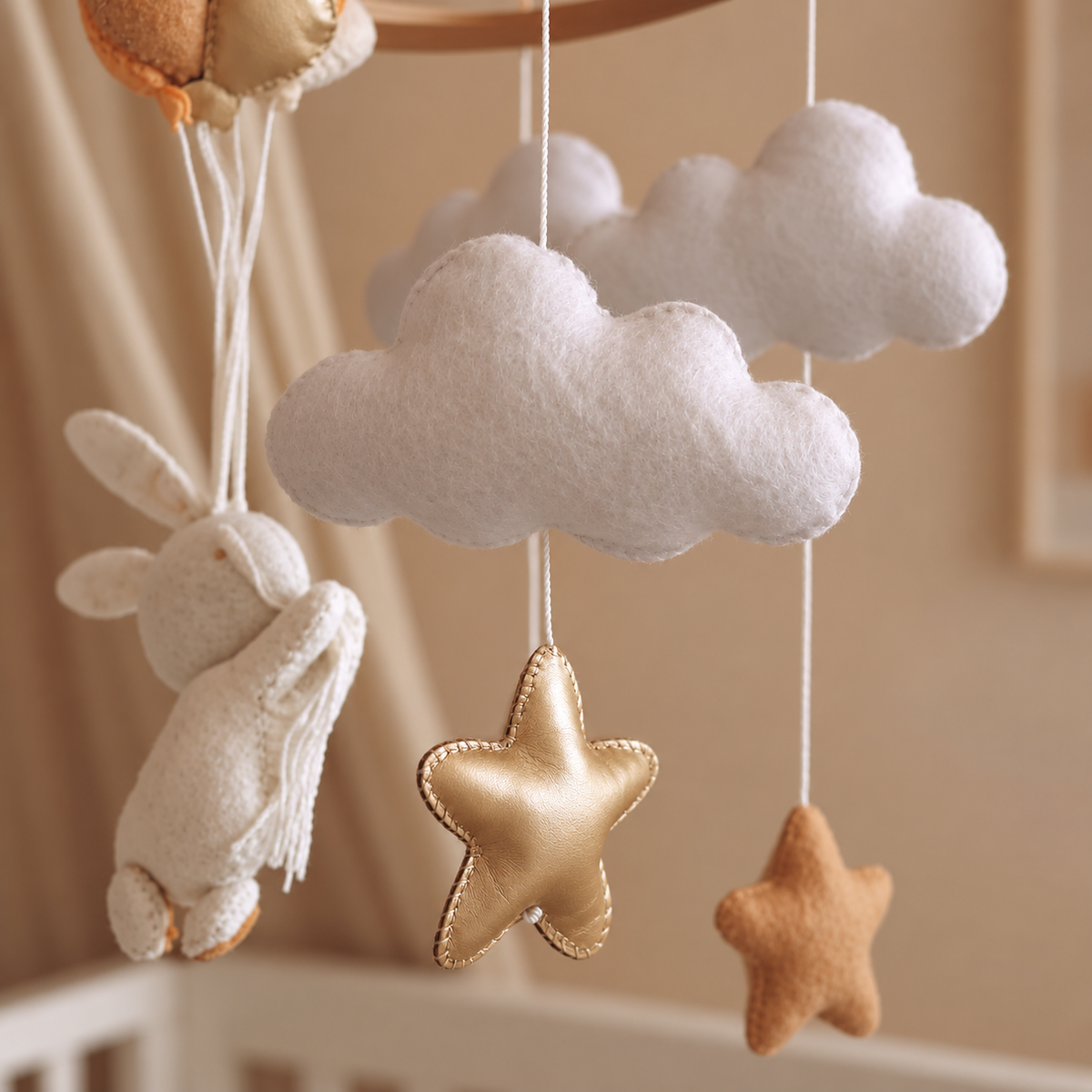 Gros plan sur le lapin blanc en feutre du mobile bébé artisanal
